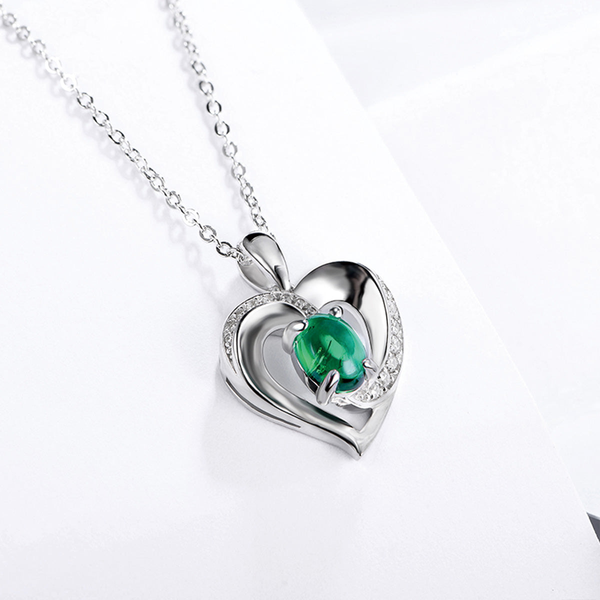 Sterling Silver Channel Setting Hollow Heart Shape Pendant with Oval Brilliant Cut Emerald Gem