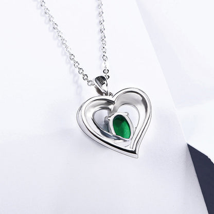 Sterling Silver Channel Setting Hollow Heart Shape Pendant with Oval Brilliant Cut Emerald Gem